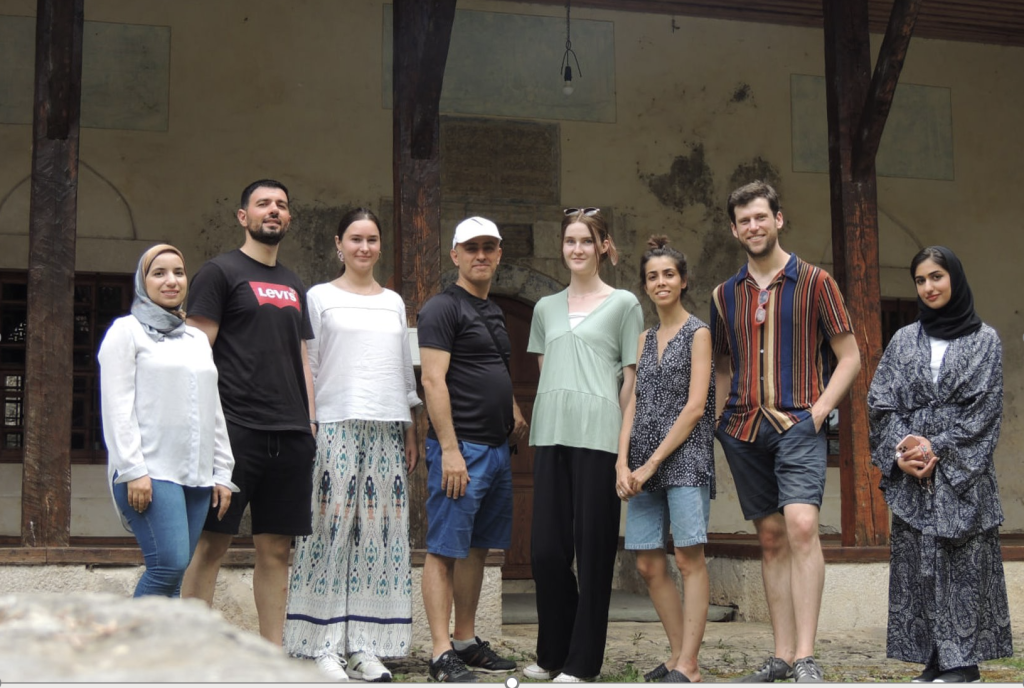 A group of students and trainers during training on the architectural recording of a historic mosque in the city of Stolac.
