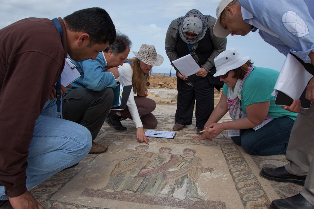 Tom Roby advises participants in a MOSAIKON course conducting a condition survey exercise of the Three Oras Mosaic at the Paphos Archeological Park, Paphos, Cyprus, photograph by Scott S. Warren