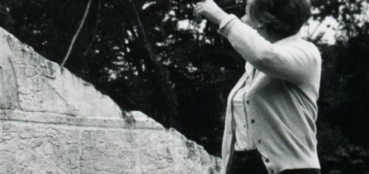 Resource of the Month October 2023 - Laura Mora stands in front of Mayan monument